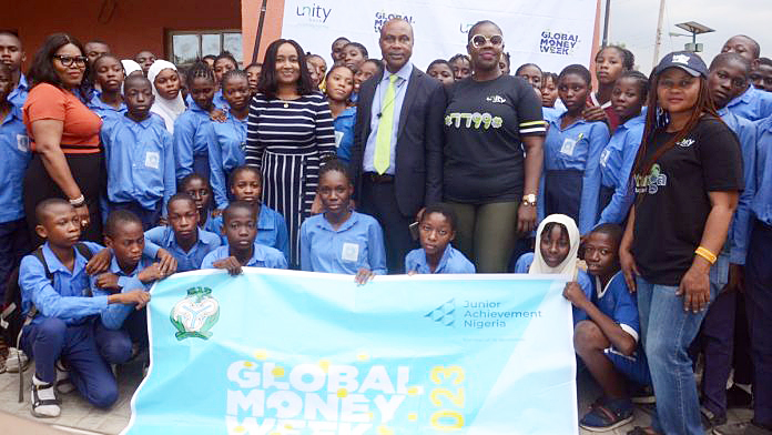 Unity Bank team in a group photo with the students