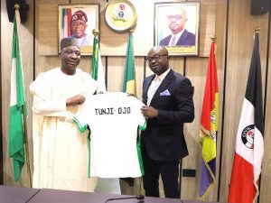 Gusau presenting a Nigerian jersey to Minister Tunji-Ojo